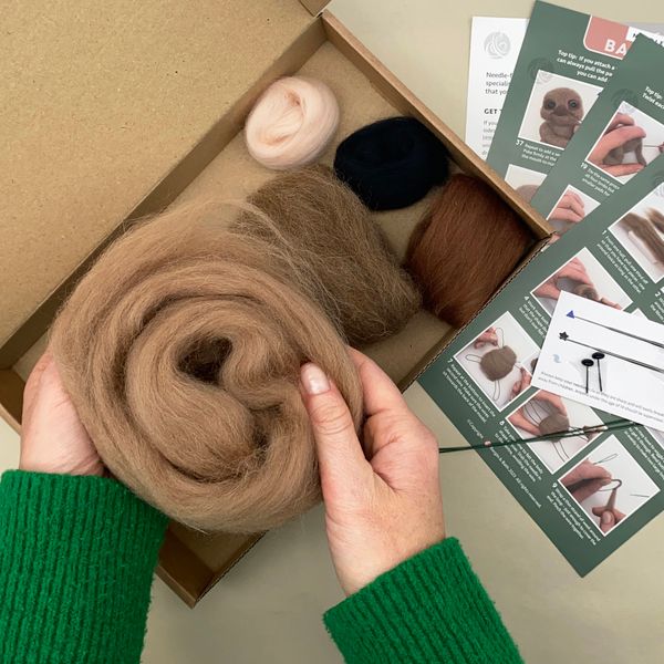 Needle Felted Baby Sloth kit open with wools and cards