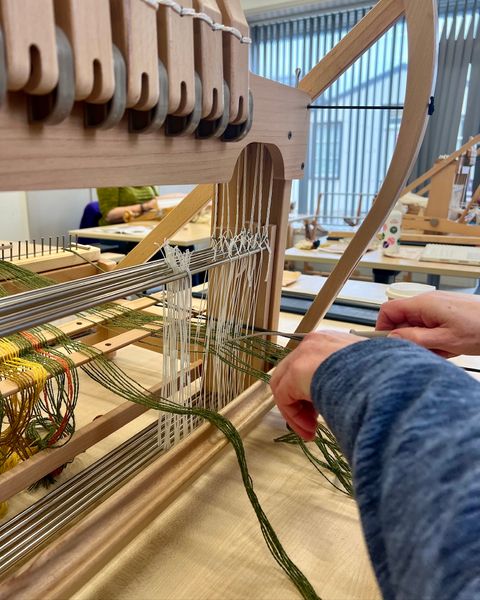 Threading the loom.