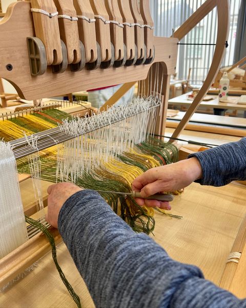 Threading the loom.