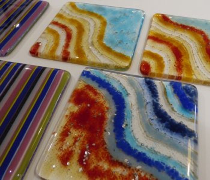 Abby made these coasters using frits, mica particles, noodles and fine glass powder