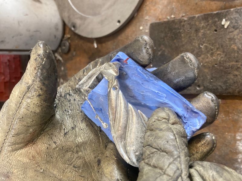 Pewter pendant, pouring pewter into a rubber mould.