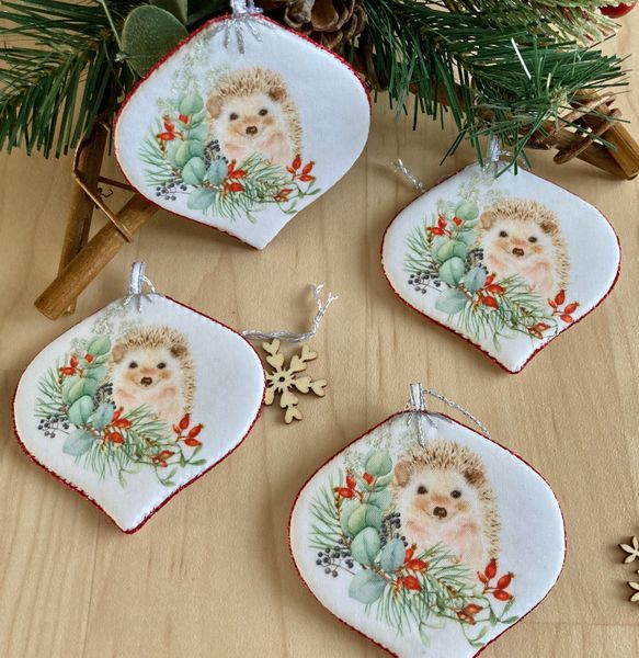 Pack of four hand crafted baubles featuring our cute winter hedgehog design