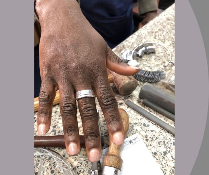 Student wearing rings made during class