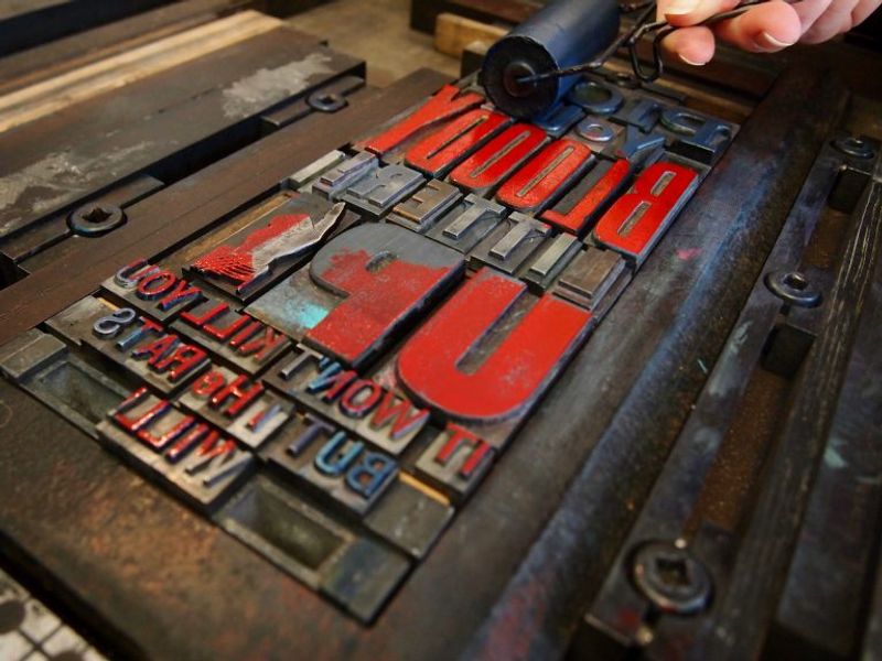 Vintage type inked up on the press