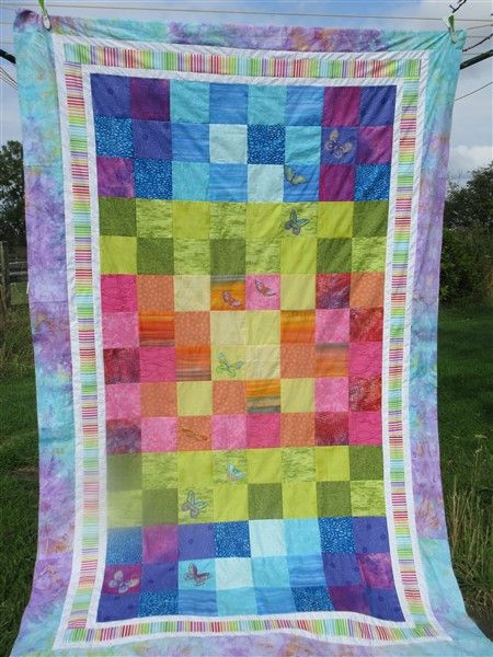 Rainbow quilt made 
using squares