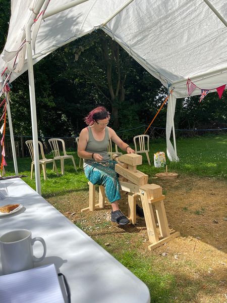 Student using the draw knife and shave horse