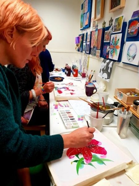 A workshop guest carefully applying fabric dyes to her beautiful Lily. Batik workshop in Yorkshire.