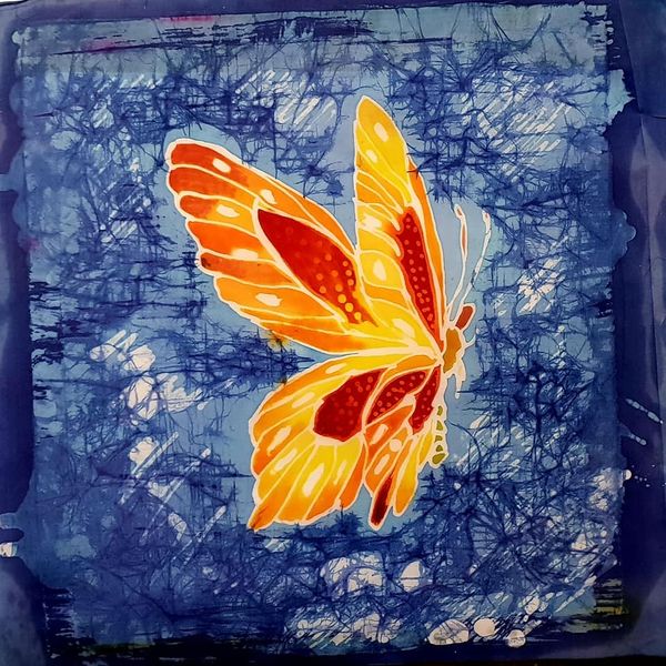 A fabulous Batik butterfly contrasting against a blue wax crackle background.
