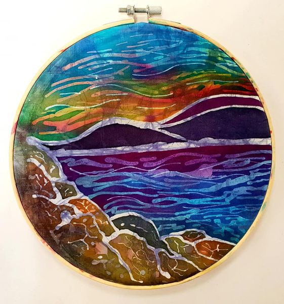 A sunset landscape in an embroidery hoop.