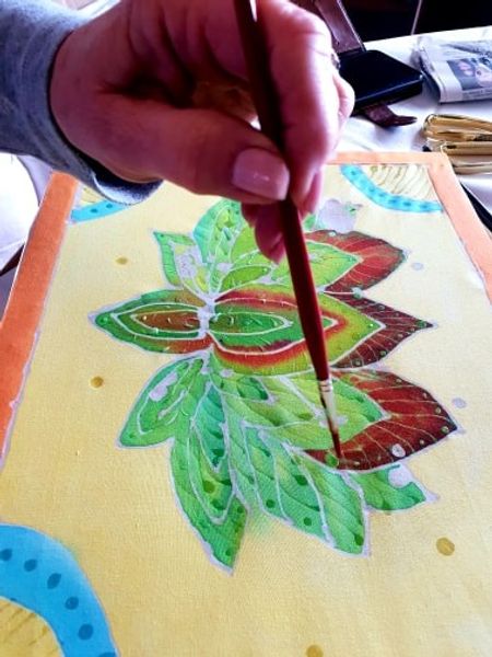 Fabric dye being applied to Batik work.