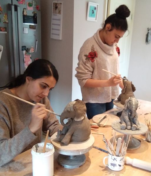 Painting their finished sculptures  at this elephant workshop