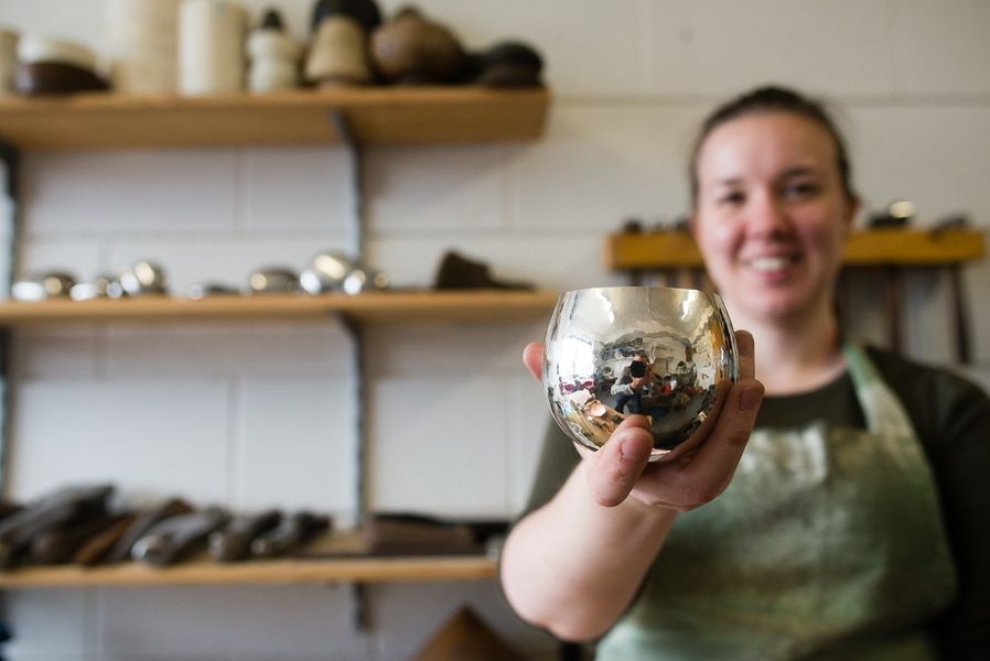 Charlotte with one of her hand raised Silver Whisky Tumblers. [Photo Credit: Ben Boswell]