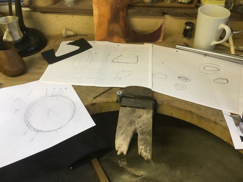 Working to a drawing, making a template to check the shape. Making the raising rings on paper.