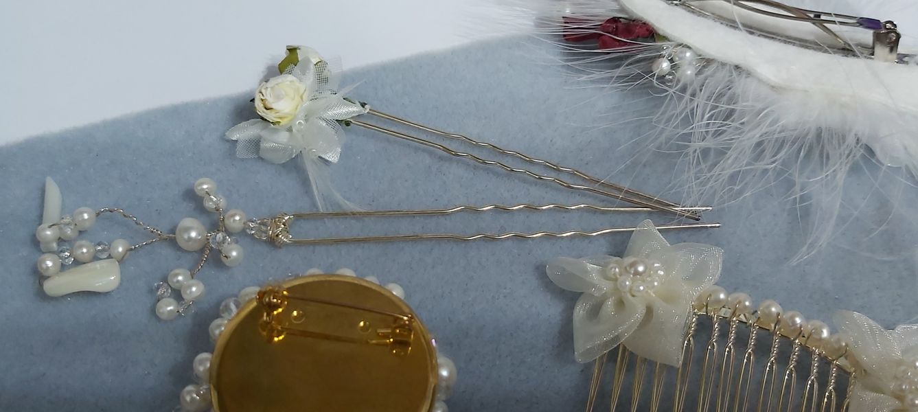 Beautiful hair grips one with 2 white rose buds and satin flower and the other with pearls wired to the long hair grip.