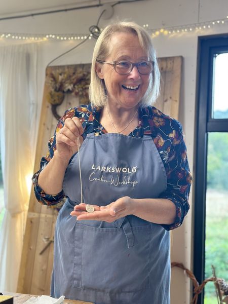 Silver Metal Clay tutor holding a pendant