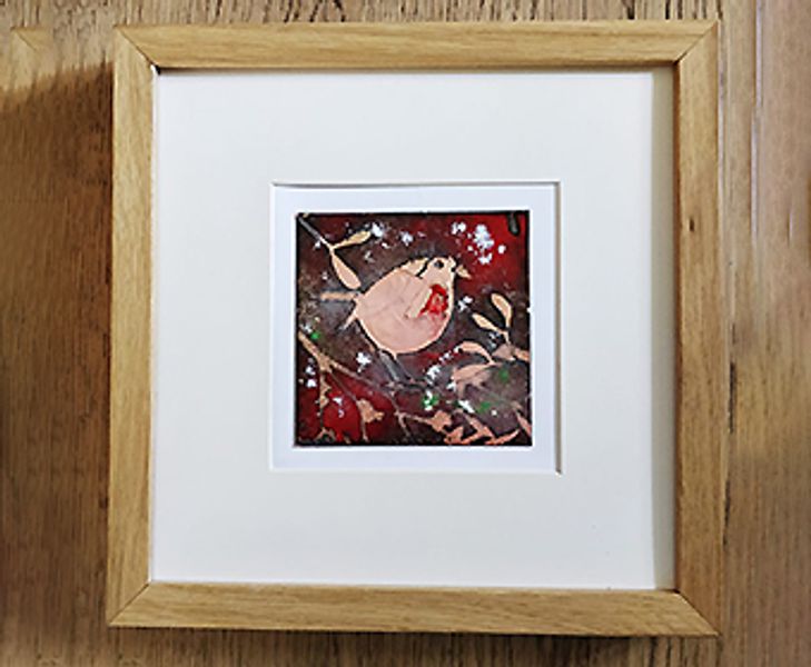 An enamelled Christmas creation mounted within a frame