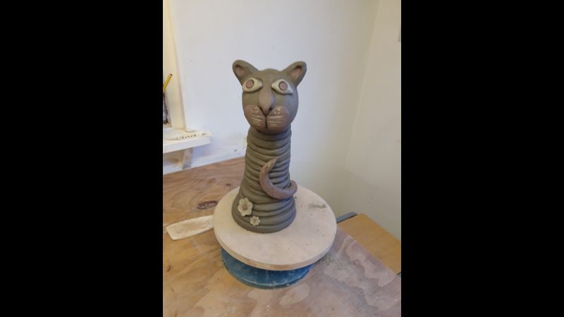 Coiled cat sculpture