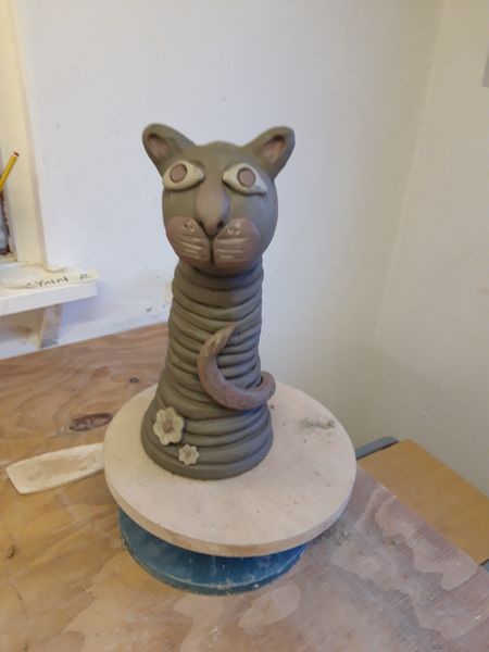 Coiled cat sculpture