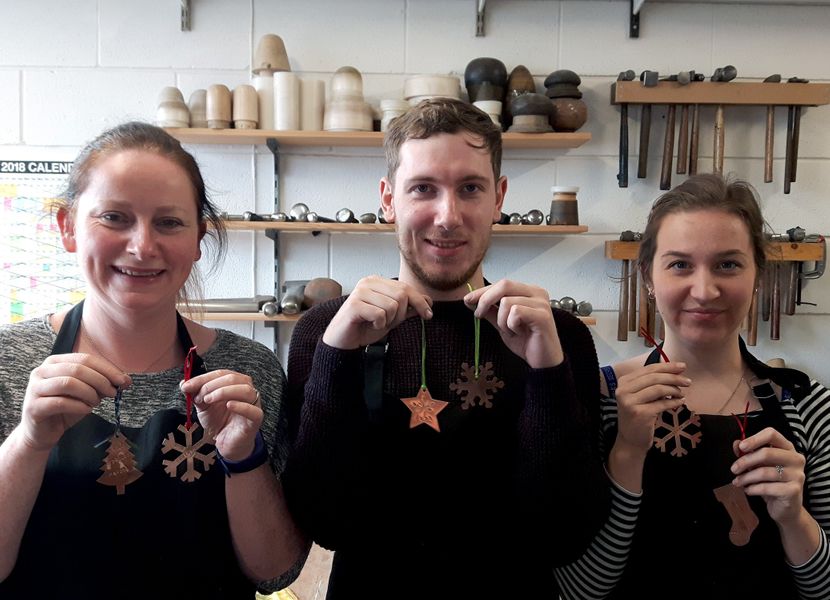 Louise, Gareth and Beth showing off their finished pieces.