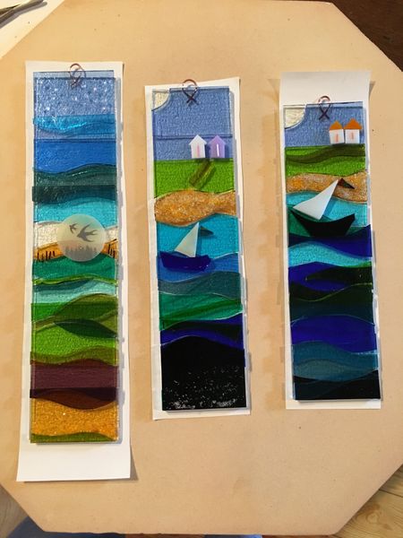 Three decorative wall hangings on the kiln shelf ready to be fired in the kiln!