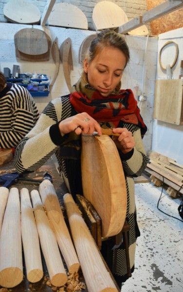 Using a spokeshave to shape and smooth the stool seat