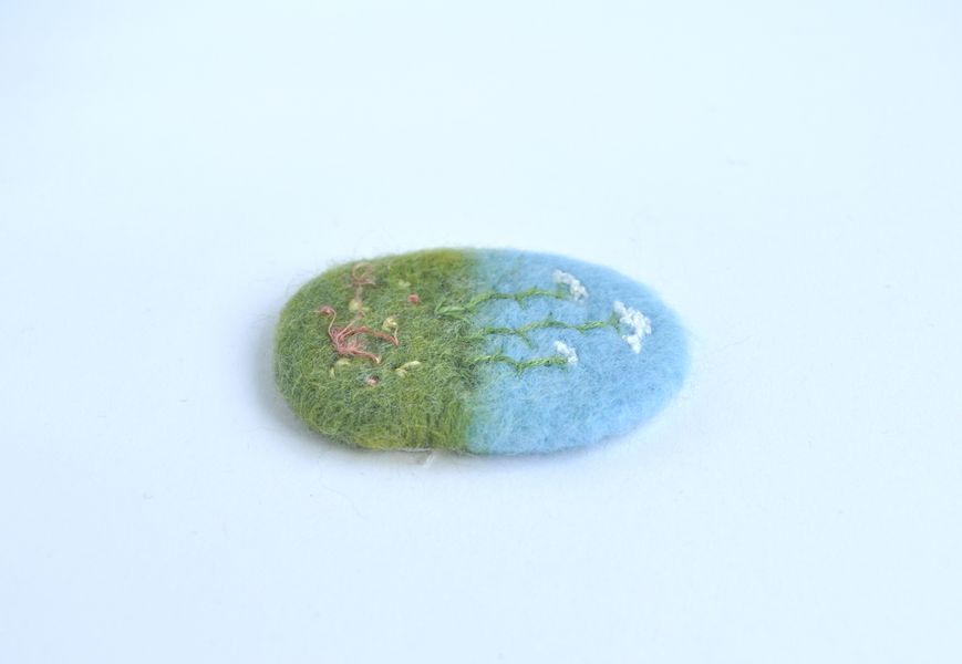 Needle felted brooch with wildflower embroidery - side view. c. Hobbz Designs