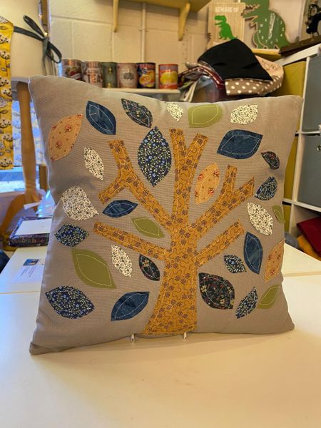 A beautiful Applique Tree Cushion completed in shades of blue & green