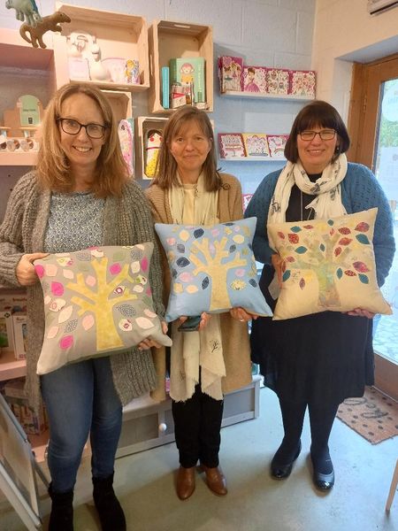 two sisters and a friend rather proud of their stunning new tree cushions