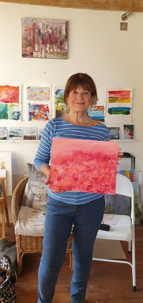 This is Mary holding her finished painting an abstract in oil on canvas board