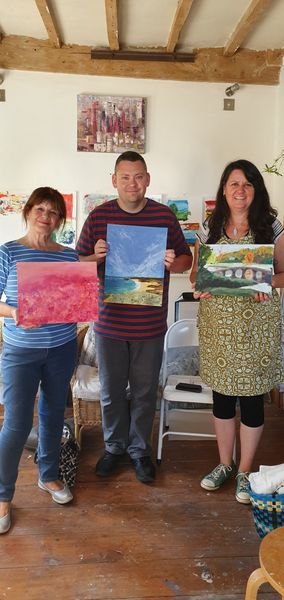 Mary, Trevor and Jeanette showing their finished paintings after just one day's tuition.