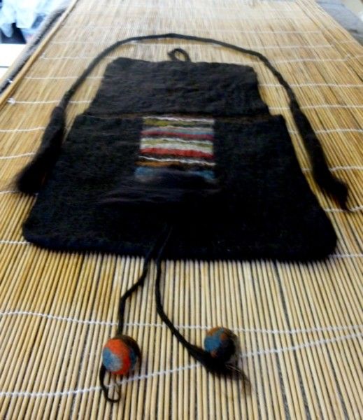 Bag laid out for felting with handles and decoration.