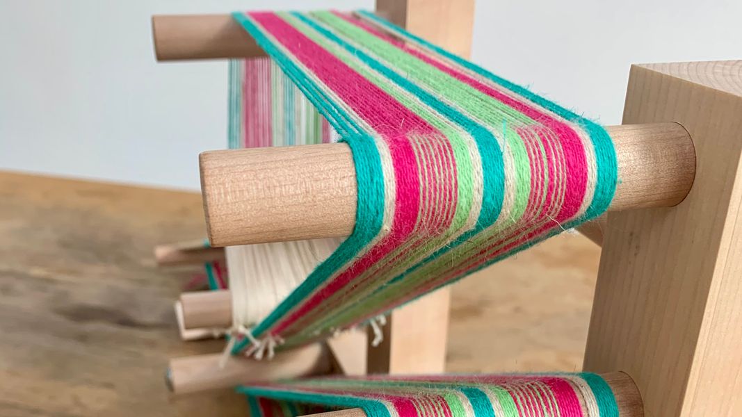 A band being woven on an inkle loom in organic cotton and linen