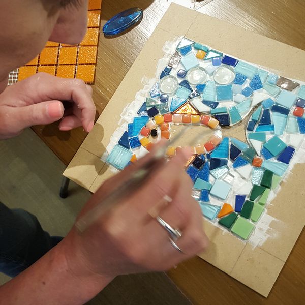A student makes her mosaic