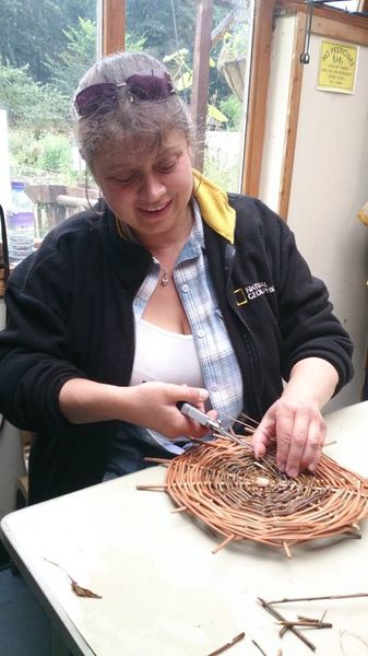 Student weaving basket bottom at Creative with Nature Todmorden West Yorkshire