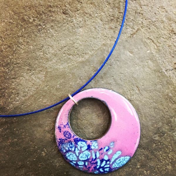 Pinks and blues combine on this stylish enamelled donut pendant