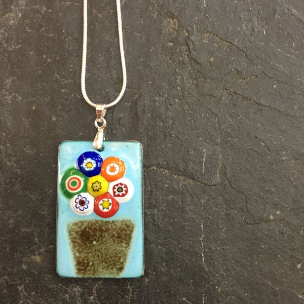 Flowers in a vase, a pendant made by Sam on the enamelling day course for beginners at Rainbow Glass Studios N16 0JL