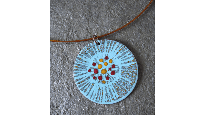 A handmade enamelled pendant, with hand painted detail