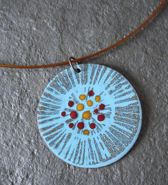 A handmade enamelled pendant, with hand painted detail
