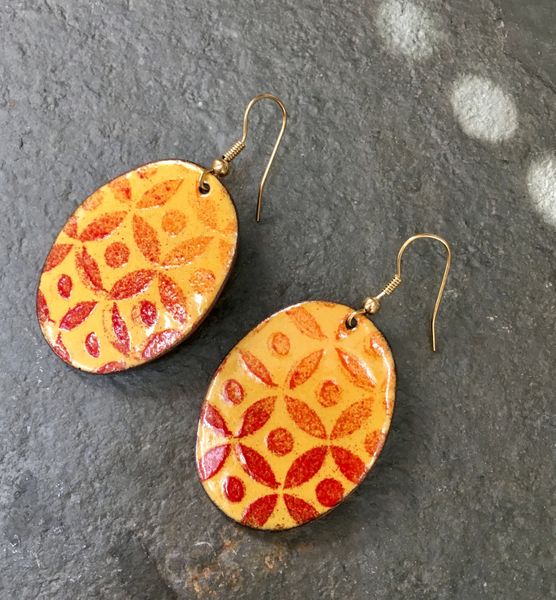 A fiery combination of colours work well on this stunning pair of enamelled earrings