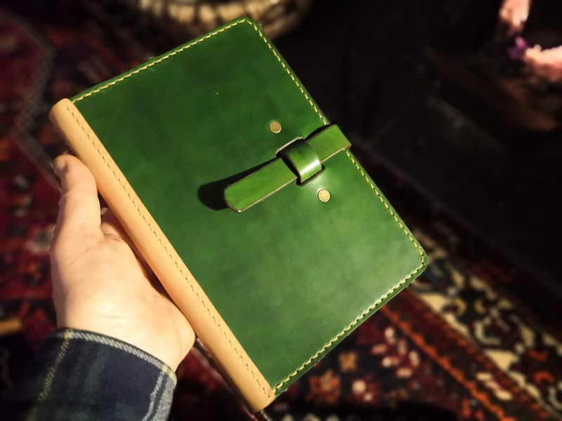 Green book with closure flap