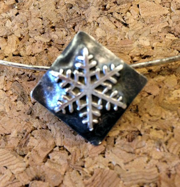 Snowflake pendant made at a West Country Creative class.
