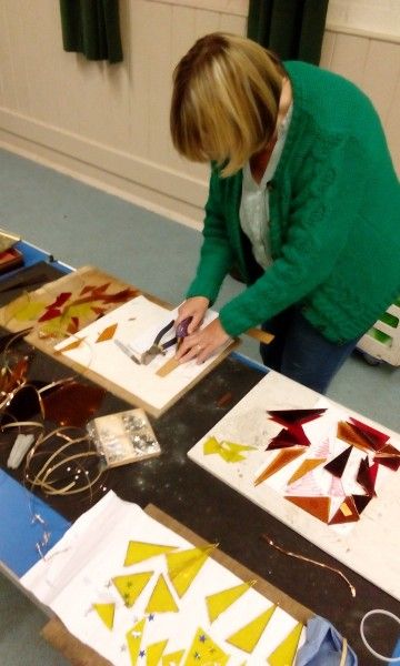 Student working on their stained glass piece