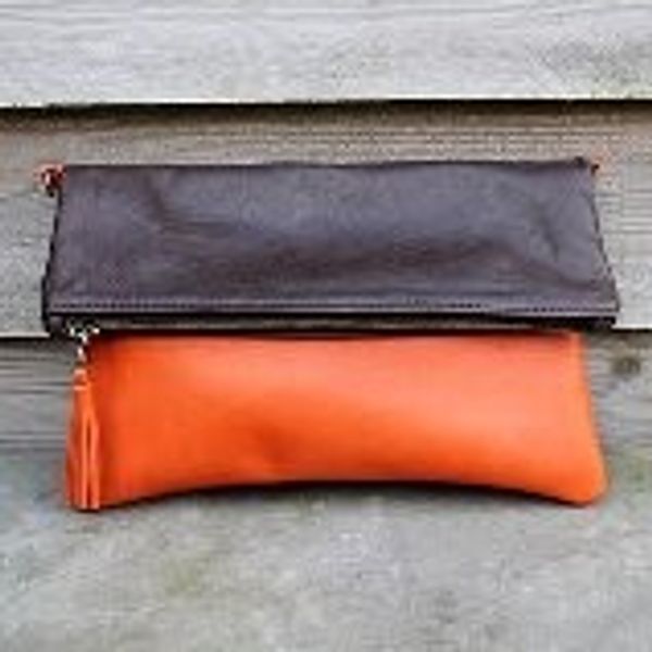 Orange and brown leather fold over clutch bag