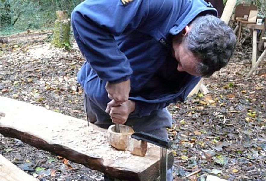 Scooping out the bowl of a kuksa with a gouge