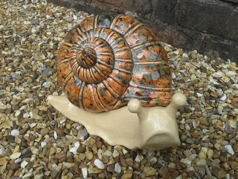 Horace the snail posing on the gravel at the Red House Glass Cone in Wordsley