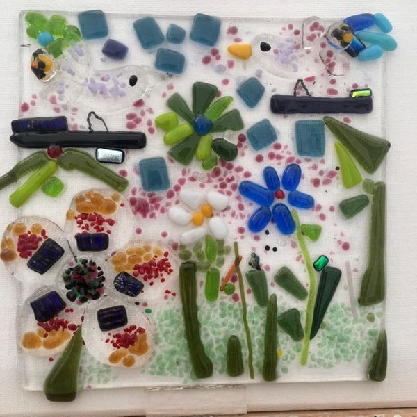 This is a fused glass panel created by a participant at the 'Kitty's and Puppies' Evening of 'Glass Fusing' workshop. Dimensions are  15cm square. Guests may choose to apply glass hooks so that it may be hung from a window, or not as it can also be displayed in a box frame.