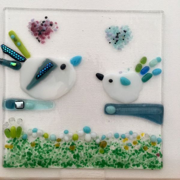 This is a fused glass panel created by a participant at the 'Kitty's and Puppies' Evening of 'Glass Fusing' workshop. Dimensions are  15cm square. Guests may choose to apply glass hooks so that it may be hung from a window, or not as it can also be displayed in a box frame.