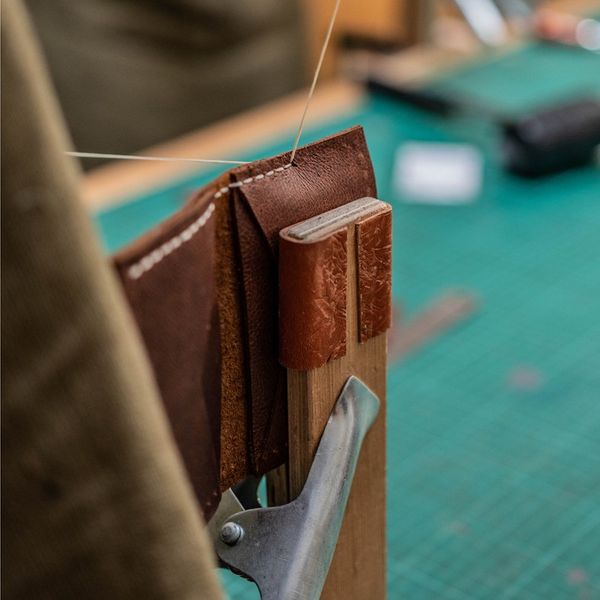 Hand stitching leather using a lacing pony