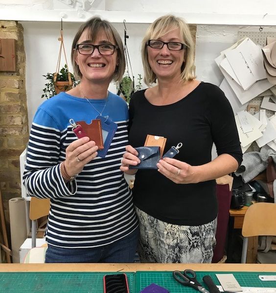 Two students with their finished items on the half day leather workshop course