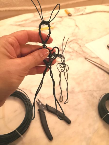 Student making an animal armature with wire